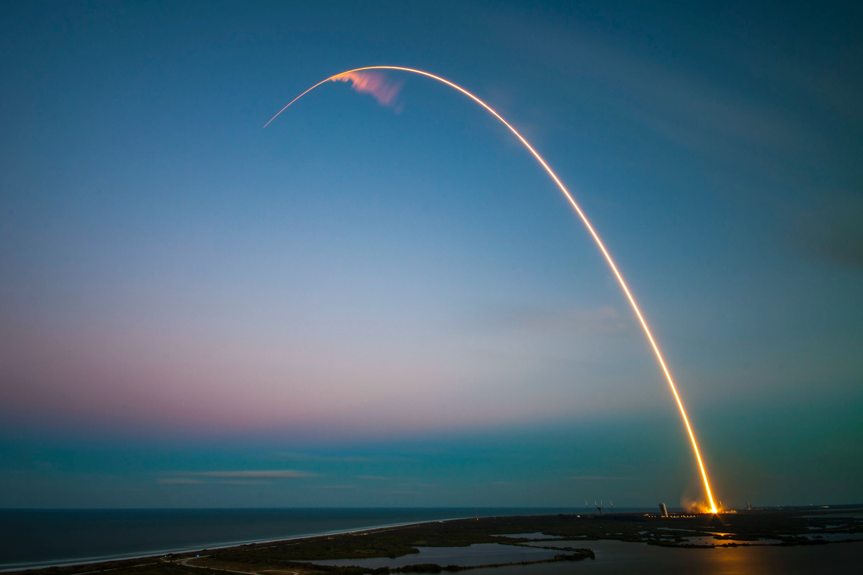 Space shuttle leaving curved trail in the sky